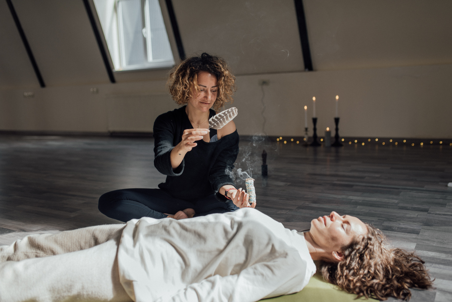  A Woman Smoking an Incense beside a Woman Lying Down